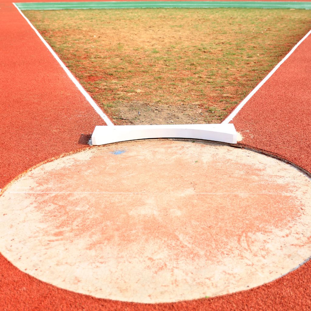 A shot put circle on a track, highlighting the track and field shot put collection offering personalized spirit wear for parents and fans.
