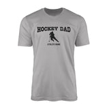 hockey dad with hockey player icon and hockey player name on a mens t-shirt with a black graphic