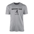 soccer dad with soccer player icon and soccer player name on a mens t-shirt with a black graphic